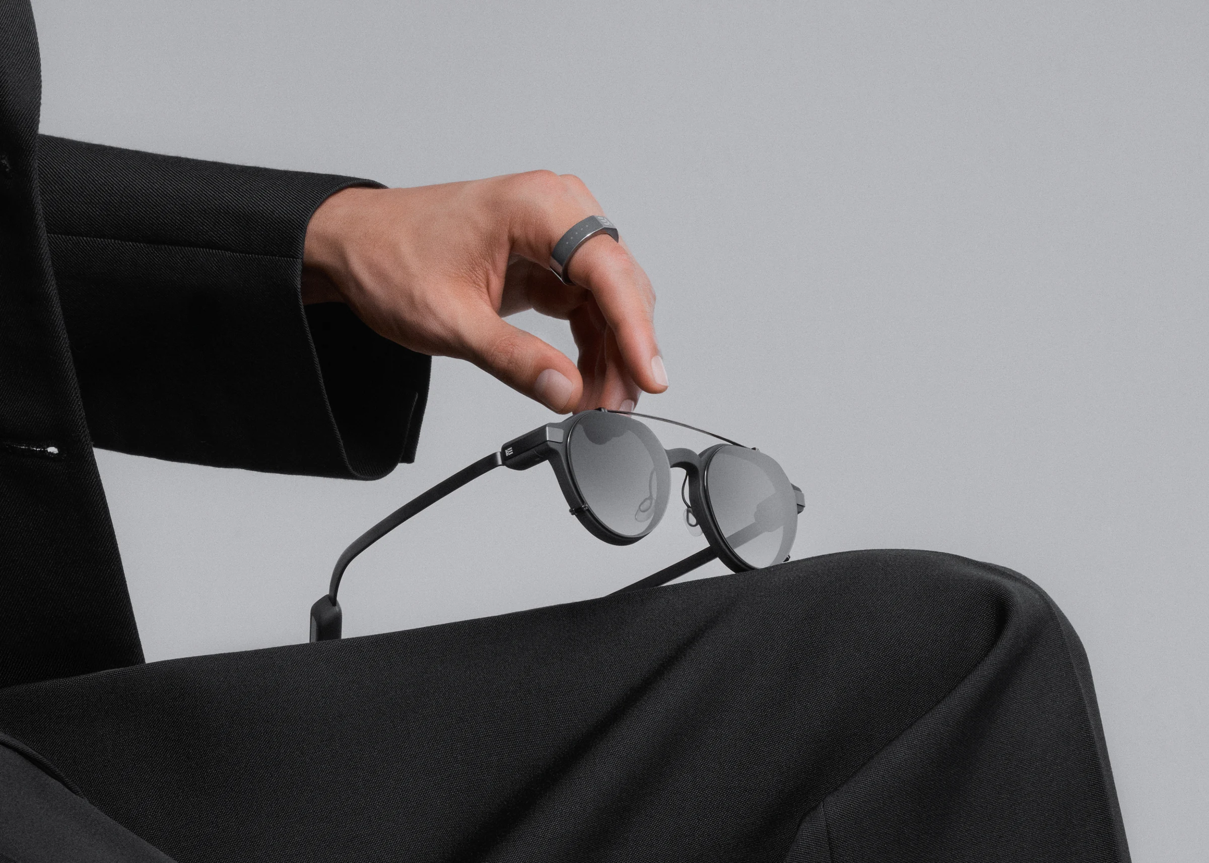 Even G2 mit magnetischem Sonnen-Clip, Hand mit Even R1 Ring – Originalbild von Even Realities